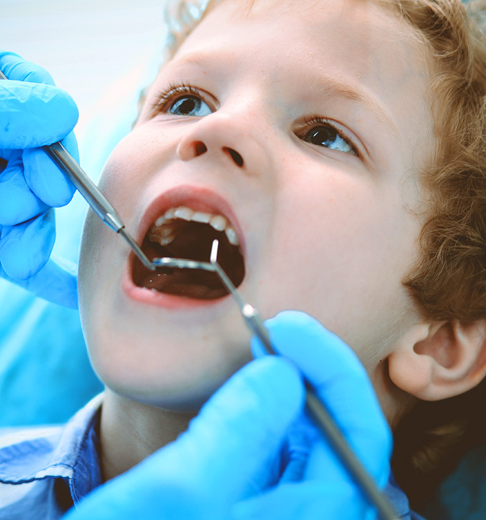 Doctor and patient child. Boy having his teeth examined with dentist. Medicine, health care and stomatology concept