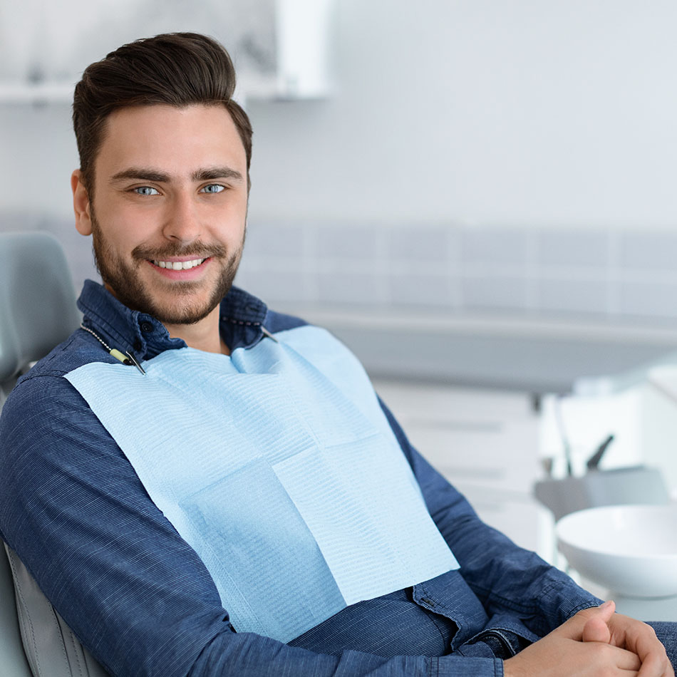 Young man patient smiling in dentistry, copy space Young man patient smiling in dentistry, copy space